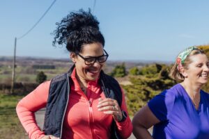 This is a photo of two women jogging. It is the header image for the Urostomy Association's 'fundraise for us' page.